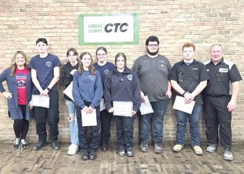 Students and instructors at Greene County CTC pose with certificates in front of a brick wall sign.