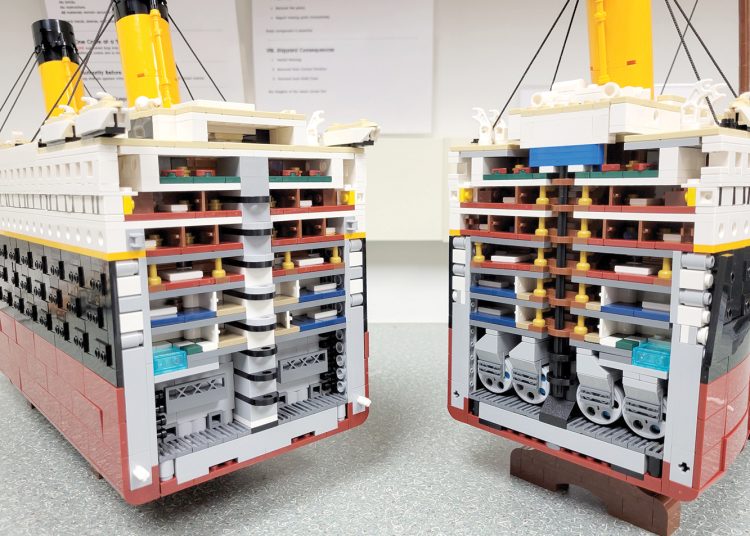 Two LEGO models with open sides reveal detailed interior layers and mechanical sections resembling a ship cross section.
