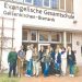 Group of educators posing outside a German school building during an international study trip