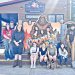Group of students posing with an Ohiopyle sign outside a market building