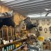 Interior of a hunting shop with mounted animals, rifles, and outdoor gear on display.
