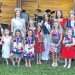Contestants and pageant royalty pose together during the Little Miss Firecracker Pageant in patriotic attire.