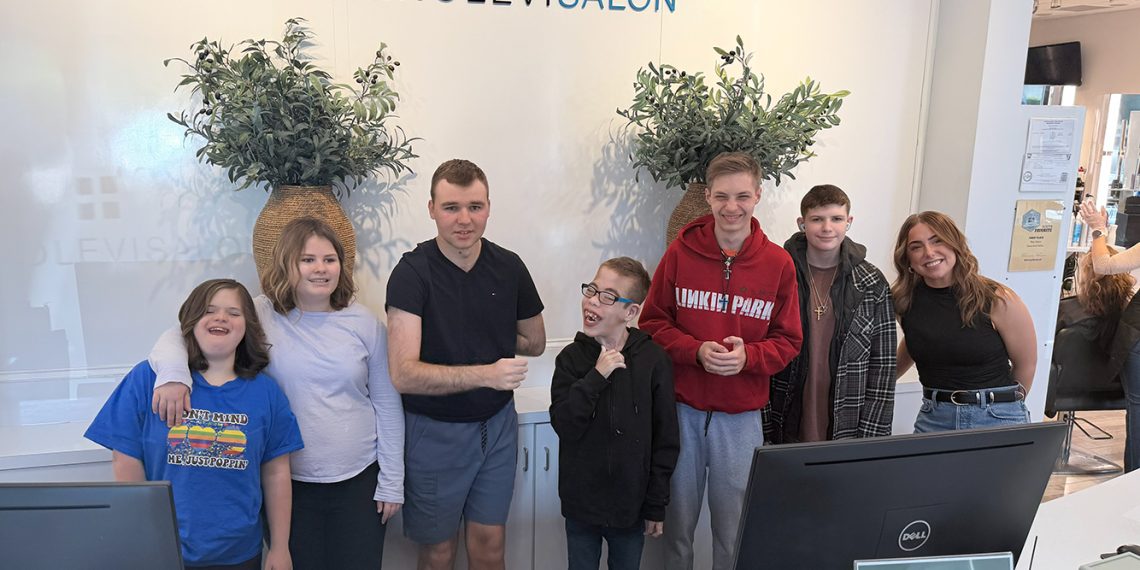 STARS Prom students pose together inside Geno Levi Salon after preparing for their special prom event.