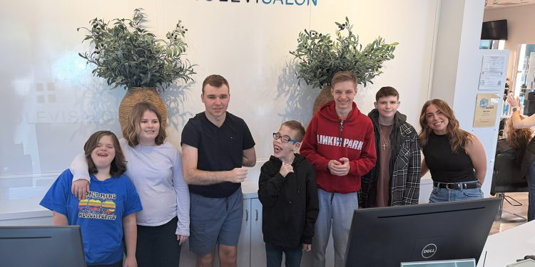 STARS Prom students pose together inside Geno Levi Salon after preparing for their special prom event.