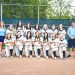 The Carmichaels Lady Mikes softball team and coaches pose together on the softball field for a team photo.