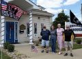 Members of the Carmichaels Borough Council stand outside the decorated borough building during the America 250 celebration in Carmichaels.