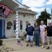 Members of the Carmichaels Borough Council stand outside the decorated borough building during the America 250 celebration in Carmichaels.