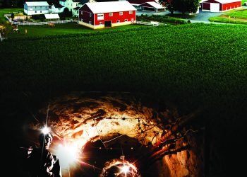 A split image shows a rural farm above an underground coal mine tunnel with a miner, representing the region's agricultural and mining heritage.