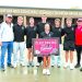 Waynesburg Central track and field athletes and coaches pose outside the high school with a sign recognizing their qualification for the PIAA Track and Field Championships.