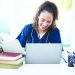 Woman, laptop or medical student books for research, education studying or college learning in university hospital. Smile, happy or healthcare nurse with technology in scholarship medicine internship.
