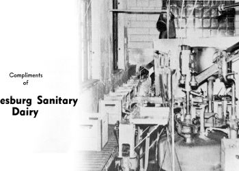 Vintage black and white photo of the Waynesburg Sanitary Dairy processing plant with industrial equipment and the company's name printed on the image.