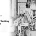 Vintage black and white photo of the Waynesburg Sanitary Dairy processing plant with industrial equipment and the company's name printed on the image.