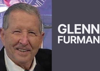 Close-up headshot of an older man smiling beside large white text that reads "GLENN FURMAN" on a grey background.
