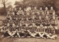 Sepia 1925 group photograph of the Waynesburg College football squad posed outdoors.