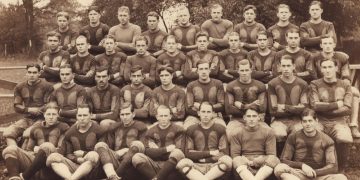 Sepia 1925 group photograph of the Waynesburg College football squad posed outdoors.