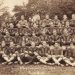 Sepia 1925 group photograph of the Waynesburg College football squad posed outdoors.