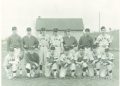 Vintage black-and-white team photograph of baseball players in C.T.H.S. uniforms posing in two rows on a grassy field.