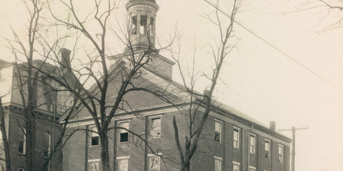 Historic circa-1930 photograph of Hanna Hall at Waynesburg College, a three-story brick building with a domed cupola surrounded by leafless trees.