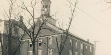 Historic circa-1930 photograph of Hanna Hall at Waynesburg College, a three-story brick building with a domed cupola surrounded by leafless trees.