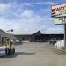 A forklift transports building materials outside Wayne Lumber & Supply in Waynesburg, Pennsylvania, with lumberyard buildings and a large Wayne Lumber Home Center sign visible.