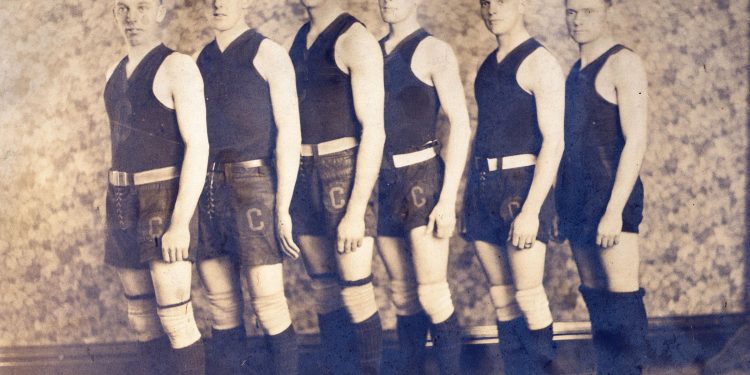 Six Cumberland Township High School basketball players pose in vintage uniforms and high-top athletic shoes for an early 20th-century team photograph.