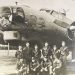 A black-and-white World War II photograph shows Hershel “Ted” Bowers and fellow American airmen posing in front of their B-17 Flying Fortress bomber, the Jub Jub Bird.