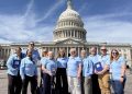 A group of cancer advocates wearing light blue shirts stand together in front of the U.S. Capitol during the American Cancer Society Cancer Action Network's advocacy event in Washington, D.C.