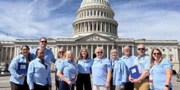A group of cancer advocates wearing light blue shirts stand together in front of the U.S. Capitol during the American Cancer Society Cancer Action Network's advocacy event in Washington, D.C.