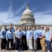 A group of cancer advocates wearing light blue shirts stand together in front of the U.S. Capitol during the American Cancer Society Cancer Action Network's advocacy event in Washington, D.C.